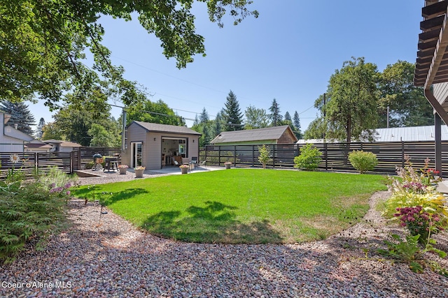 838 N Government Way, Coeur Dalene, ID 83814 - fenced backyard featuring an outdoor structure and a patio area