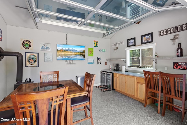 838 N Government Way, Coeur Dalene, ID 83814 - dining space with beverage cooler, dark aggregate flooring, and bar