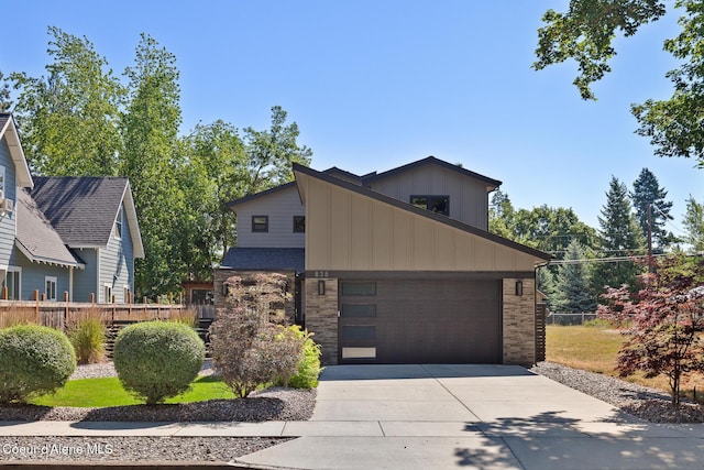 838 N Government Way, Coeur Dalene, ID 83814 - view of front of house with driveway, a garage, and board and batten siding