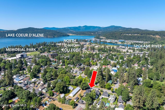838 N Government Way, Coeur Dalene, ID 83814 - aerial view of property and surrounding area featuring a water and mountain view and a heavily wooded area