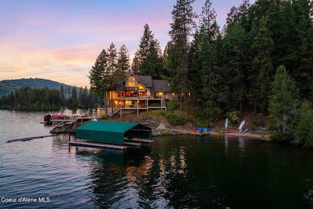1750 W Valhalla Rd, Coeur Dalene, ID 83814 - dock with a water and mountain view, boat lift, and a view of trees