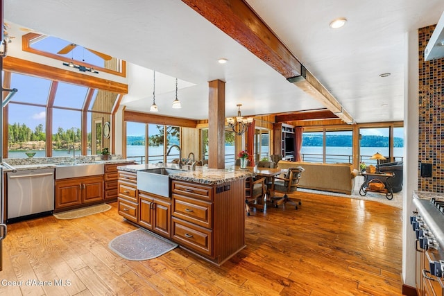 1750 W Valhalla Rd, Coeur Dalene, ID 83814 - kitchen with dishwasher, a chandelier, light wood finished floors, light stone countertops, and brown cabinets