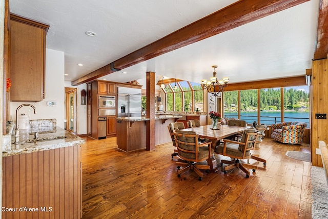 1750 W Valhalla Rd, Coeur Dalene, ID 83814 - dining room featuring beam ceiling, light wood-style floors, a chandelier, plenty of natural light, and recessed lighting