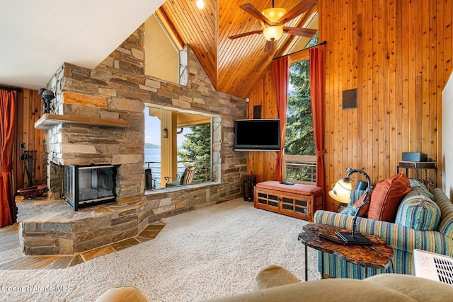 1750 W Valhalla Rd, Coeur Dalene, ID 83814 - carpeted living area with high vaulted ceiling, wooden ceiling, a ceiling fan, a stone fireplace, and wood walls