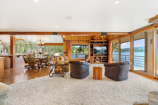 1750 W Valhalla Rd, Coeur Dalene, ID 83814 - living area with wood finished floors, wood walls, a chandelier, plenty of natural light, and recessed lighting