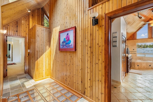 1750 W Valhalla Rd, Coeur Dalene, ID 83814 - hall with stone tile flooring, wood walls, high vaulted ceiling, and wood ceiling