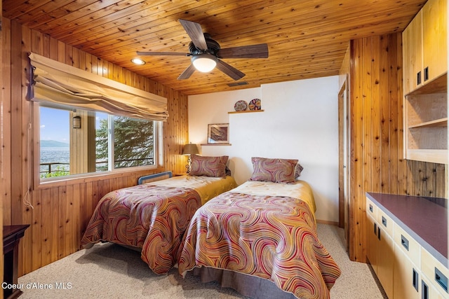 1750 W Valhalla Rd, Coeur Dalene, ID 83814 - bedroom featuring wood ceiling, wooden walls, carpet, ceiling fan, and a water view