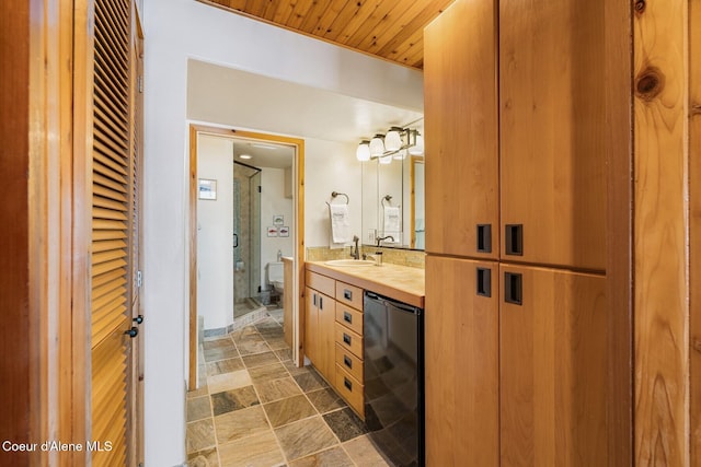 1750 W Valhalla Rd, Coeur Dalene, ID 83814 - full bathroom featuring stone tile flooring, vanity, a closet, and wood ceiling
