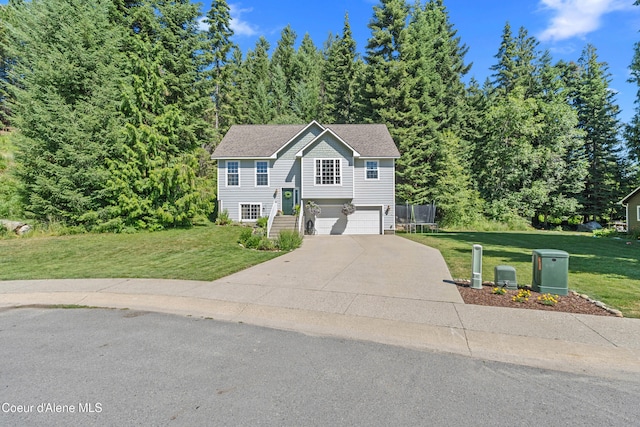 187 White Way, Priest River, ID 83856 - raised ranch with concrete driveway, a front lawn, a garage, and a trampoline