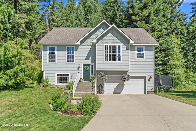 187 White Way, Priest River, ID 83856 - split foyer home with a trampoline, an attached garage, driveway, and a front yard