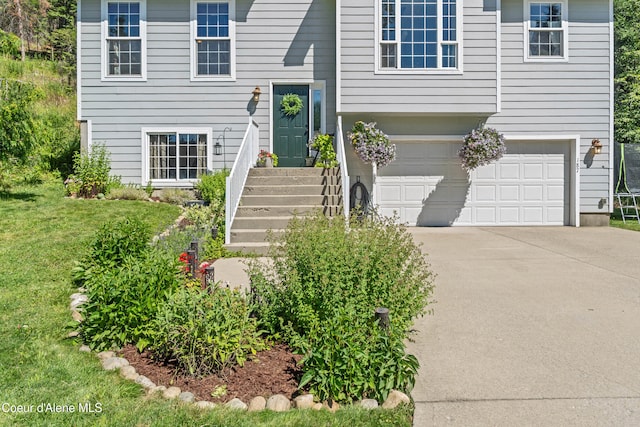 187 White Way, Priest River, ID 83856 - view of front of home featuring a garage, driveway, and a front lawn
