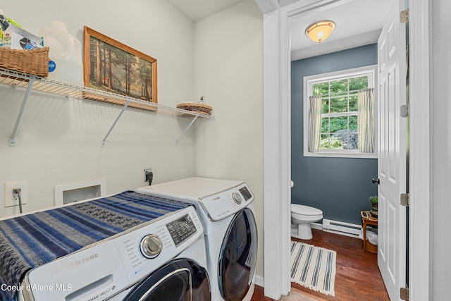 187 White Way, Priest River, ID 83856 - laundry room featuring washing machine and clothes dryer, a baseboard heating unit, and wood finished floors