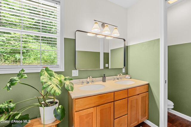 187 White Way, Priest River, ID 83856 - bathroom with plenty of natural light, double vanity, and wood finished floors