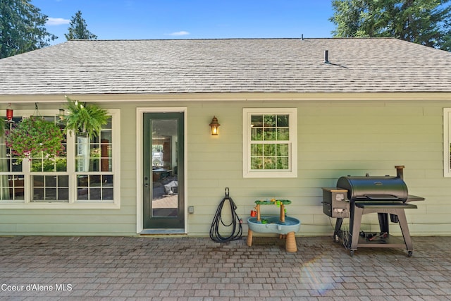 187 White Way, Priest River, ID 83856 - doorway to property with a patio area and a shingled roof