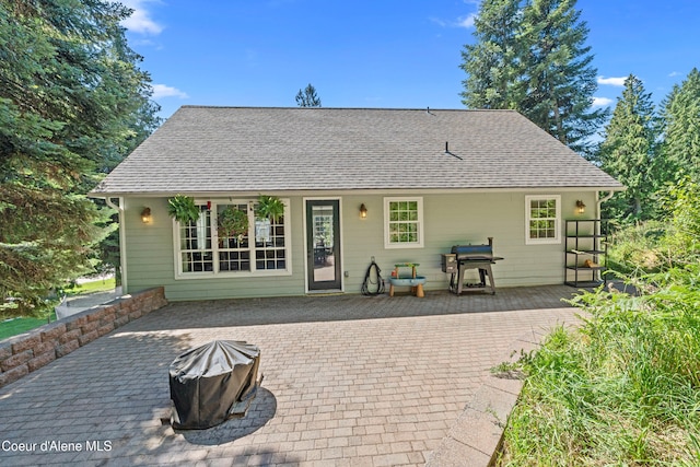187 White Way, Priest River, ID 83856 - back of property featuring a shingled roof and a patio