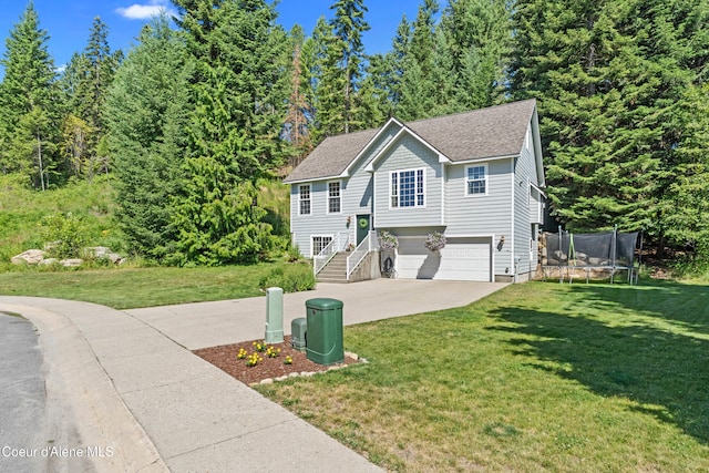 187 White Way, Priest River, ID 83856 - raised ranch featuring driveway, a garage, a trampoline, a front lawn, and roof with shingles