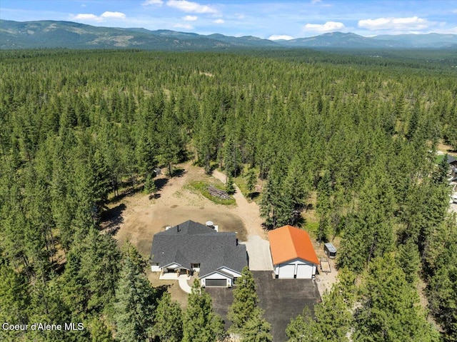 388 Wyatt Ln, Spirit Lake, ID 83869 - drone / aerial view of a heavily wooded area and a mountainous background
