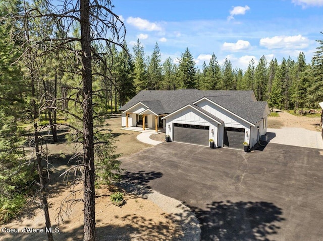 388 Wyatt Ln, Spirit Lake, ID 83869 - view of front of house with a garage, driveway, board and batten siding, and a shingled roof
