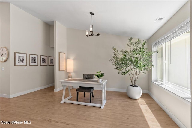 388 Wyatt Ln, Spirit Lake, ID 83869 - home office featuring light wood finished floors, a chandelier, and lofted ceiling