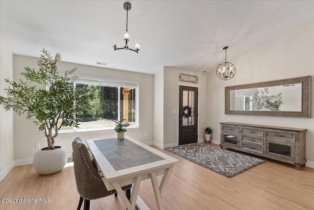 388 Wyatt Ln, Spirit Lake, ID 83869 - dining area with a chandelier and wood finished floors