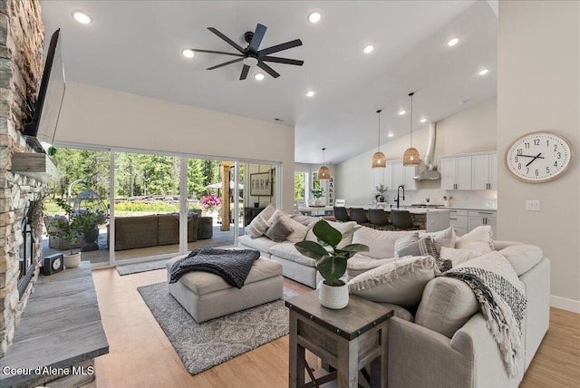 388 Wyatt Ln, Spirit Lake, ID 83869 - living area featuring ceiling fan, high vaulted ceiling, a fireplace, recessed lighting, and light wood-style flooring
