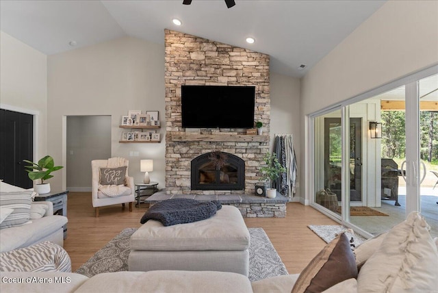 388 Wyatt Ln, Spirit Lake, ID 83869 - living area with high vaulted ceiling, wood finished floors, a ceiling fan, and a stone fireplace