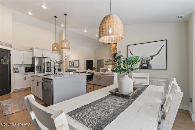 388 Wyatt Ln, Spirit Lake, ID 83869 - dining area featuring high vaulted ceiling, light wood finished floors, and recessed lighting