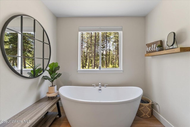 388 Wyatt Ln, Spirit Lake, ID 83869 - bathroom with a freestanding bath and wood finished floors