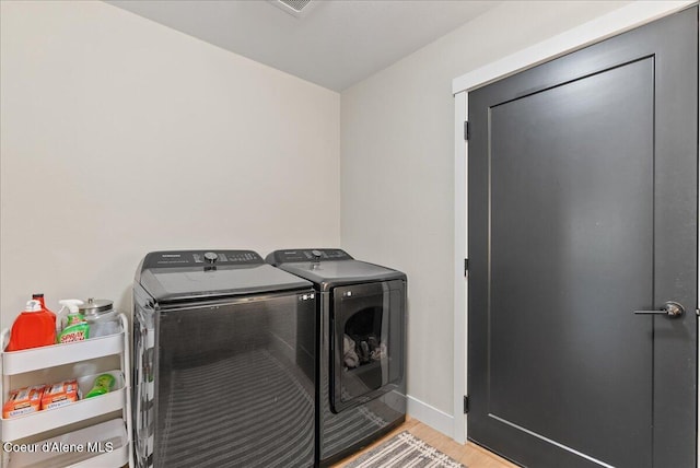 388 Wyatt Ln, Spirit Lake, ID 83869 - laundry area with washing machine and dryer and wood finished floors
