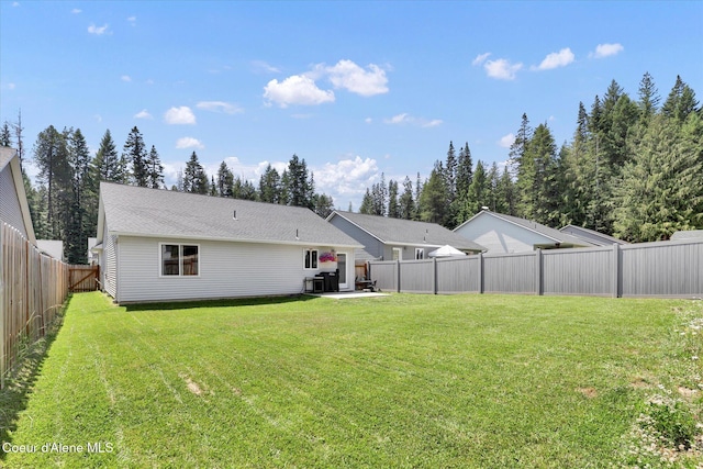 67 Bingham Way, Priest River, ID 83856 - back of house featuring a fenced backyard and a patio area