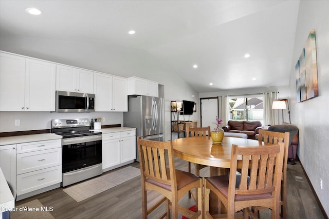 67 Bingham Way, Priest River, ID 83856 - kitchen with appliances with stainless steel finishes, dark wood-style flooring, lofted ceiling, white cabinetry, and light countertops