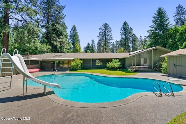 9603 N Strahorn Rd, Hayden Lake, ID 83835 - view of swimming pool featuring a water slide, a patio area, and a hot tub