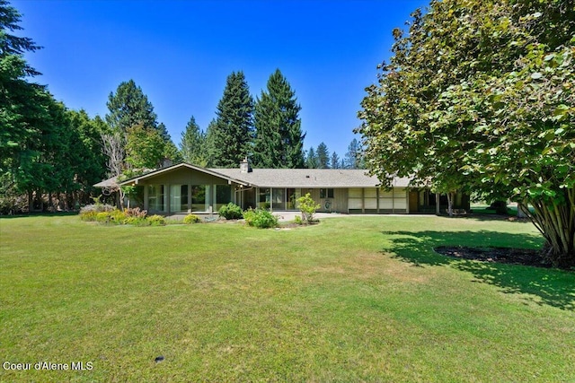 9603 N Strahorn Rd, Hayden Lake, ID 83835 - view of front facade with a garage, a front yard, and a chimney