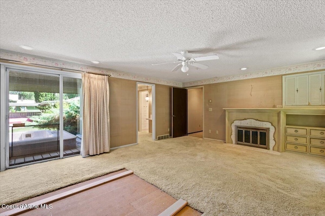 9603 N Strahorn Rd, Hayden Lake, ID 83835 - unfurnished living room with a textured ceiling, a high end fireplace, carpet flooring, a ceiling fan, and recessed lighting