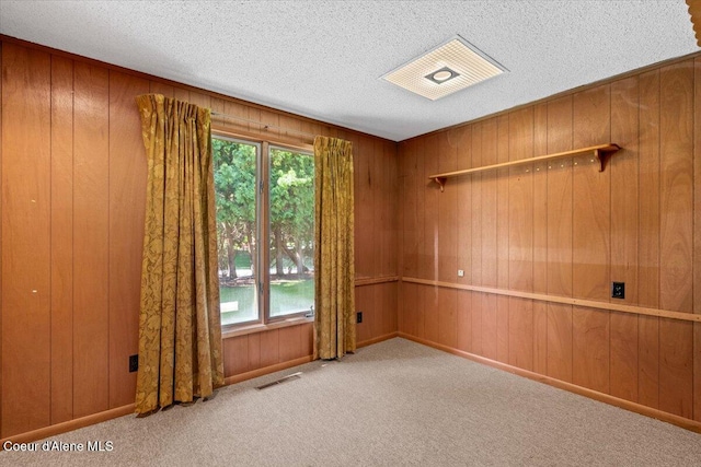 9603 N Strahorn Rd, Hayden Lake, ID 83835 - carpeted spare room featuring wooden walls and a textured ceiling