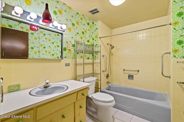 9603 N Strahorn Rd, Hayden Lake, ID 83835 - full bath featuring tile patterned floors, tile walls, wallpapered walls, shower / bath combination, and vanity