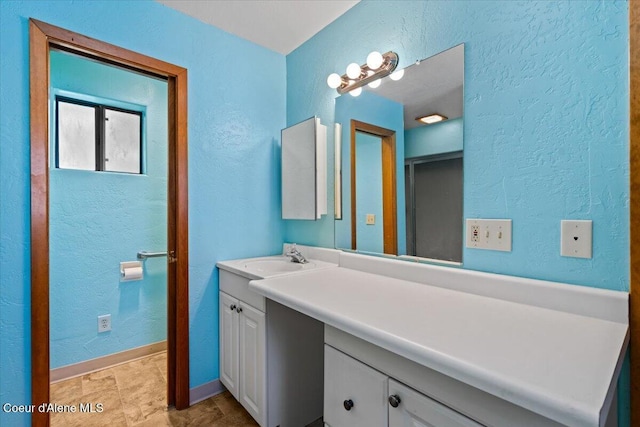 9603 N Strahorn Rd, Hayden Lake, ID 83835 - bathroom with vanity and a textured wall