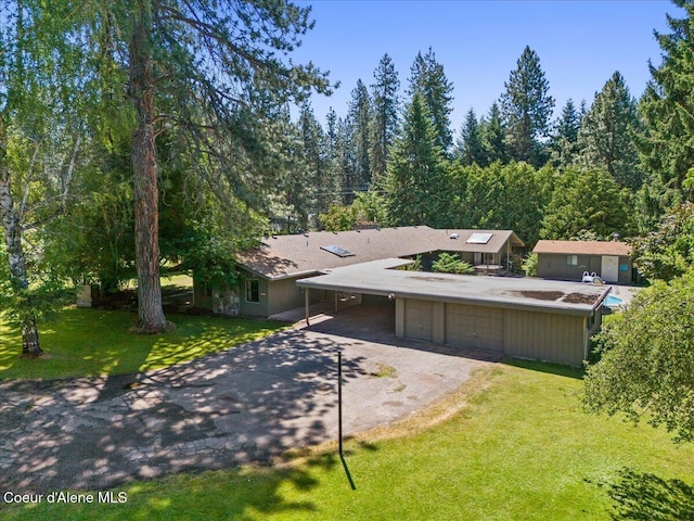 9603 N Strahorn Rd, Hayden Lake, ID 83835 - mid-century inspired home with asphalt driveway, a front yard, and a carport