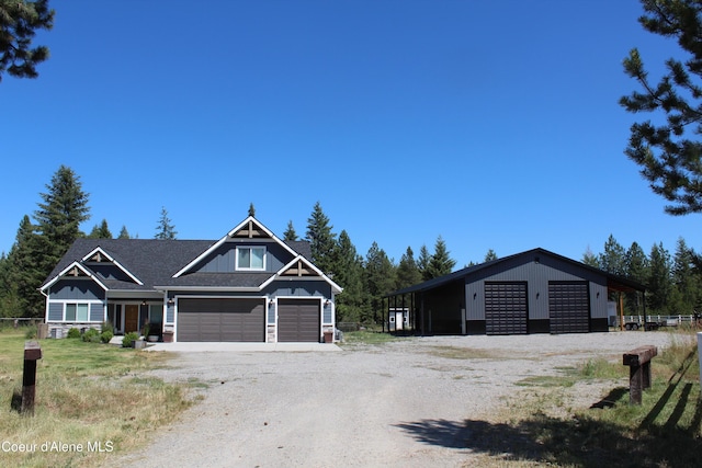23426 N Massif Rd, Rathdrum, ID 83858 - view of front of house featuring dirt driveway, a detached garage, and board and batten siding