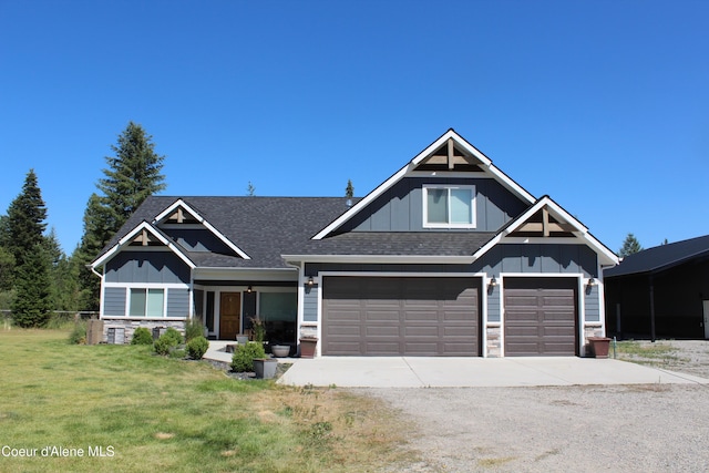 23426 N Massif Rd, Rathdrum, ID 83858 - craftsman-style home featuring board and batten siding, concrete driveway, and stone siding