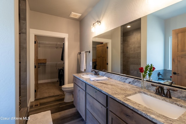 23426 N Massif Rd, Rathdrum, ID 83858 - bathroom featuring wood finished floors, double vanity, and a walk in closet
