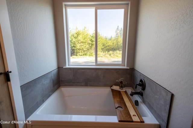 23426 N Massif Rd, Rathdrum, ID 83858 - bathroom with a garden tub and a textured wall