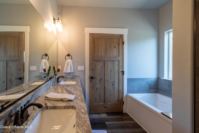 23426 N Massif Rd, Rathdrum, ID 83858 - full bathroom with wood finished floors, double vanity, and a bath