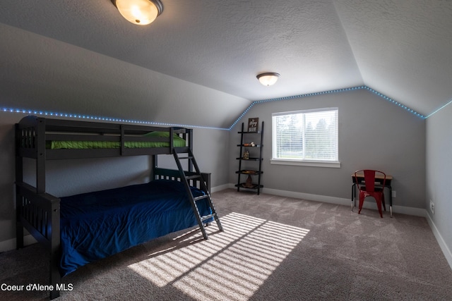 23426 N Massif Rd, Rathdrum, ID 83858 - bedroom with vaulted ceiling, carpet floors, and a textured ceiling