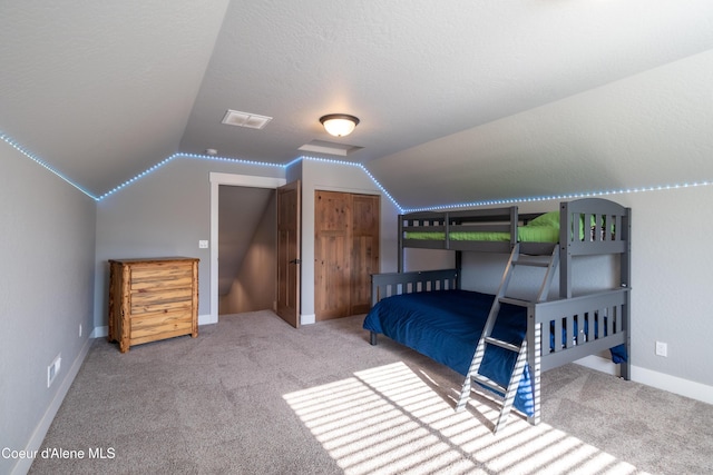 23426 N Massif Rd, Rathdrum, ID 83858 - bedroom featuring carpet floors, lofted ceiling, and a textured ceiling