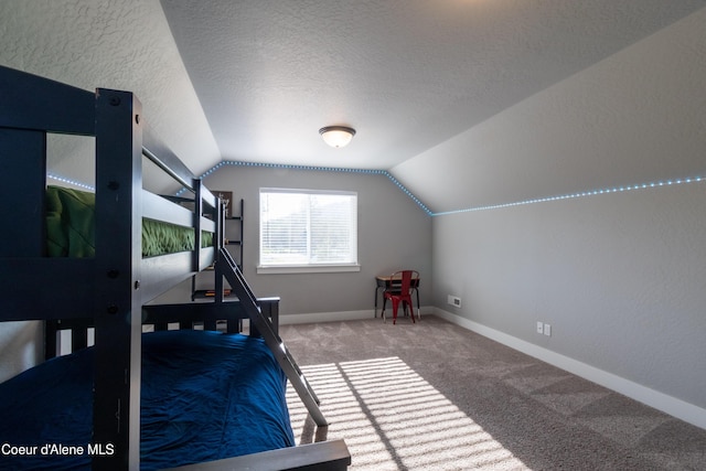 23426 N Massif Rd, Rathdrum, ID 83858 - bedroom with vaulted ceiling, carpet floors, and a textured ceiling