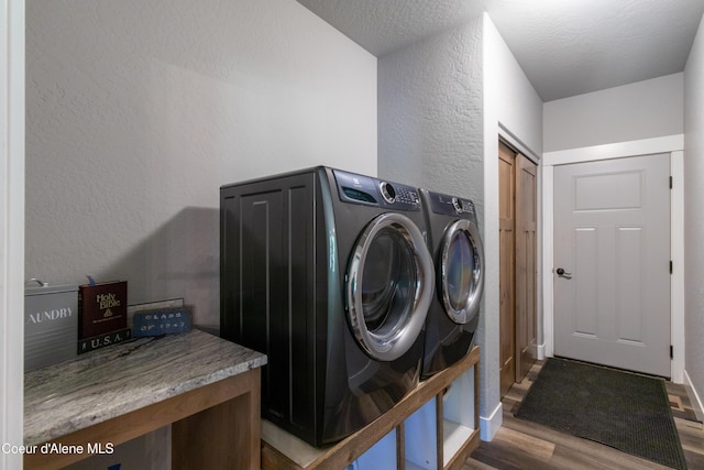 23426 N Massif Rd, Rathdrum, ID 83858 - washroom with a textured wall, wood finished floors, and separate washer and dryer