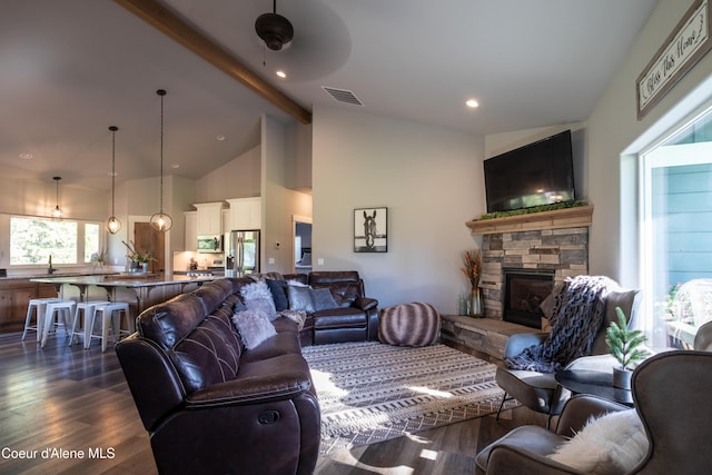 23426 N Massif Rd, Rathdrum, ID 83858 - living room with dark wood-type flooring, beamed ceiling, a stone fireplace, and high vaulted ceiling