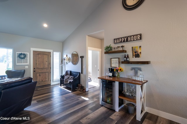 23426 N Massif Rd, Rathdrum, ID 83858 - foyer with wine cooler, high vaulted ceiling, and dark wood-style flooring