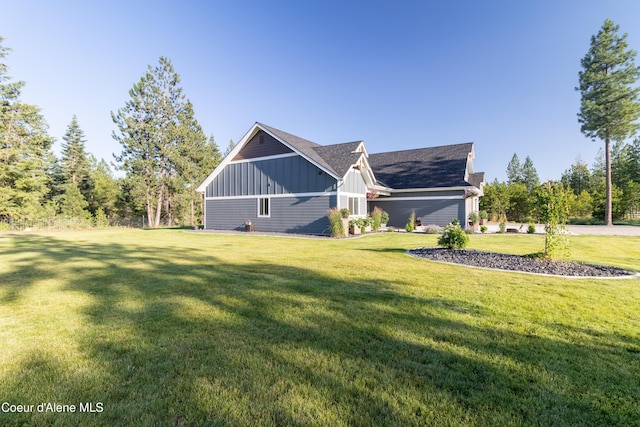 23426 N Massif Rd, Rathdrum, ID 83858 - view of home's exterior featuring board and batten siding and a yard